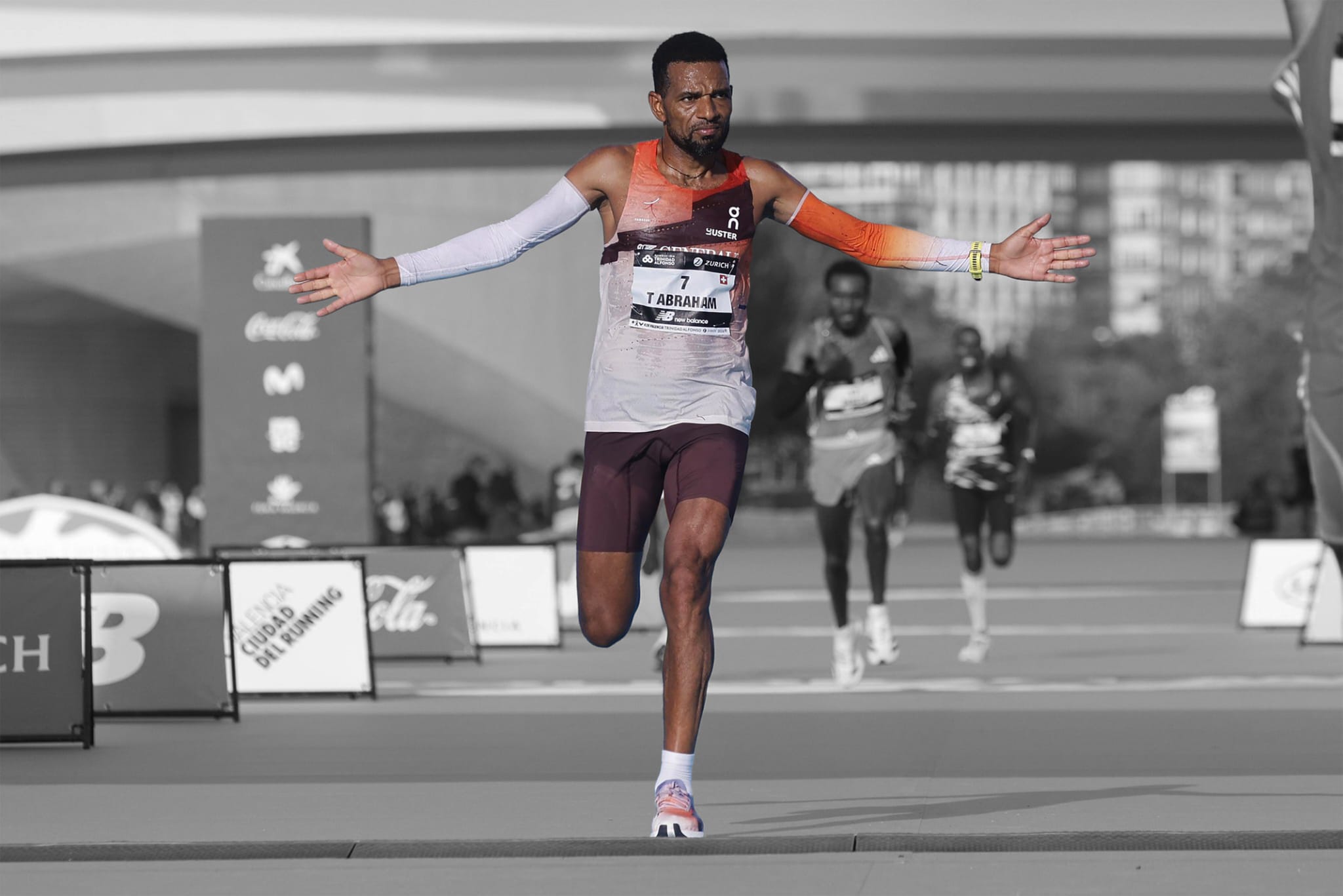 Tadesse Abraham crossing the finish line