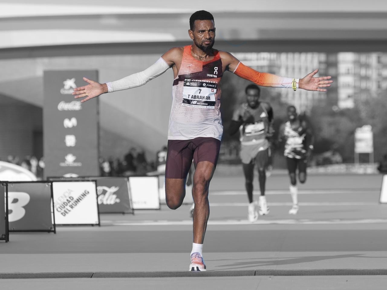 Tadesse Abraham crossing the finish line